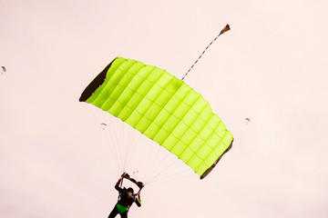 Photo of people jumping with parachute in a beautiful clean day.