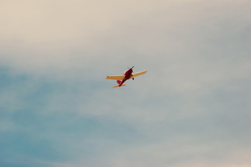 Photo of small airplane flying in a beautiful clean summer day.