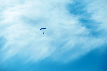 Photo of people jumping with parachute in a beautiful clean day.