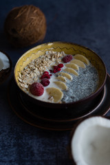 Oatmeal with chia seed, bananas and oranges served in a bowl