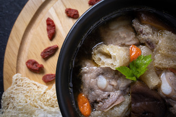 
Stewed bamboo pulp soup with Chinese medicine on a wooden floor.