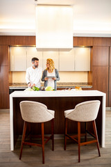 Couple cooking in the modern kitchen and using  digital tablet