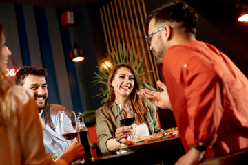 Young people having dinner in the restaurant