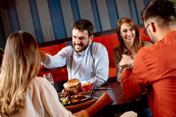 Young people having dinner in the restaurant