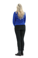 Fototapeta premium old woman in bright clothes stands back full length isolated on