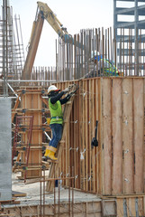 KUALA LUMPUR, MALAYSIA -MARCH 05, 2020: Construction workers installing & fabricating timber formwork at the construction site. The formworks made from timber and plywood. 