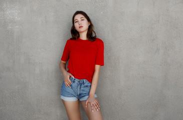 Naklejka premium shot of stylish young asian woman against grey background.