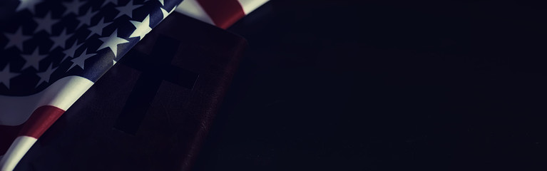 American flag and holy bible book on a mirror background. Symbol of the United States and religion....