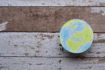 An illustration of the earth on the white wooden board.