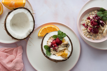 Overhead view of oatmeal with chia seed, .raspberries, bananas and oranges
