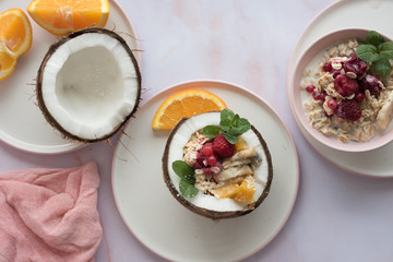 Overhead view of oatmeal with chia seed, .raspberries, bananas and oranges