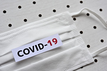 A disposable mask and a piece of paper printed with the letters 