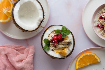 Overhead view of oatmeal with chia seed, .raspberries, bananas and oranges