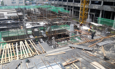 
KUALA LUMPUR, MALAYSIA -MARCH 05, 2020: Construction workers installing & fabricating timber formwork at the construction site. The formworks made from timber and plywood. 