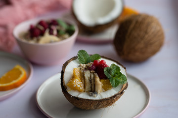 Overhead view of oatmeal with chia seed, .raspberries, bananas and oranges