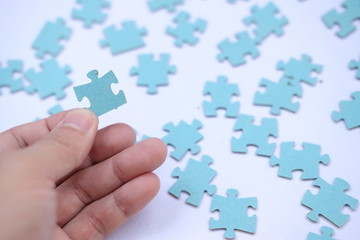 hand holding puzzle piece