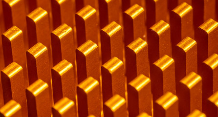 Background abstraction of orange radiator for the processor in the form of columns lined up in a row. Macro photography