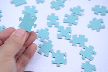 Businessman to connect couple puzzle piece on table background. one part of whole.symbol of association and connection.business strategy