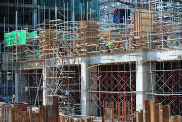 KUALA LUMPUR, MALAYSIA -MARCH 13, 2020: Column timber form work and reinforcement bar at the construction site. Installed by construction workers. The structure supported by temporary wood support.