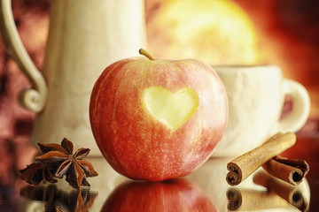 Fresh apples on a wooden board. Harvest of red apples. Fruits and cinnamon on the table.