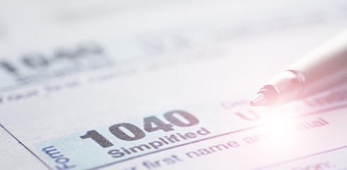 Annual tax reporting. Tax form on the table. Financial statements for signature.