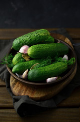 Fresh cucumbers with herbs on plate