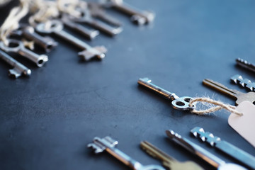 Set of vintage keys for a lock. Retro keys on a dark stone background. The concept of choosing the...