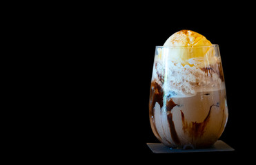 A glass of ice chocolate drink with whipping cream and icecream. A refreshment drink and dessert to...