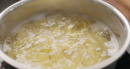 tagliatelle in boiling water closeup