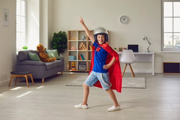 Boy hero in pilots costume and helmet playing role of superhero at home © Studio Romantic