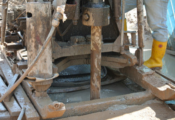 MALACCA, MALAYSIA -FEBRUARY 4, 2015: Construction workers handling the soil investigation machine at the construction site. 