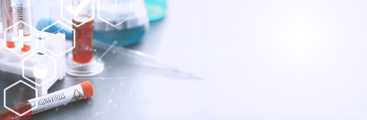 Background tubes with tests for coronavirus. Laboratory studies of viral diseases. Blood sample for testing the dangerous virus coronavirus in the body.