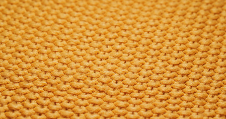 Yellow knitted duvet texture close up