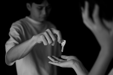 泣きながら鍵を渡す男性