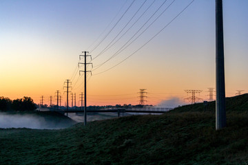 Fototapeta na wymiar Foggy sunrise powerlines