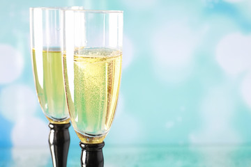 Background with tall glasses for sparkling wines. Champagne and spray in glass glasses. Celebratory drink with reflection.