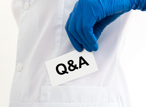 Q and A text word inscription acronym on paperin hands of doctor. medical questions and answers concept