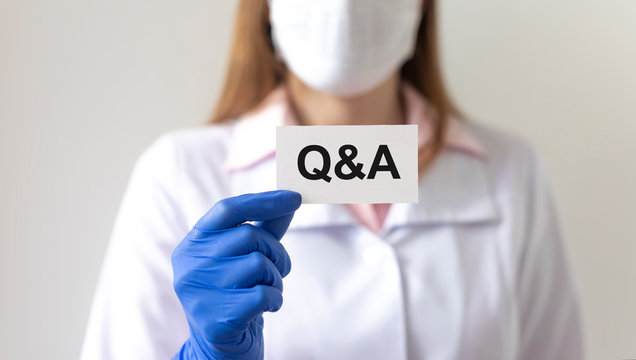 Q and A text word inscription acronym on paperin hands of doctor. medical questions and answers concept