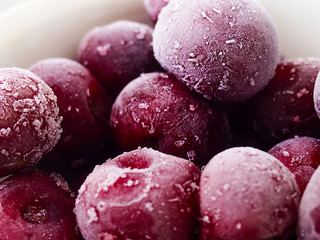 Frozen sweet cherry on black background.