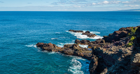 Marvelous shore. Large boulder among the waves in the sea. Hawaii 