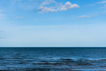 Gentle sea waves and cloudy blue sky In Hua Hin, Thailand, Sea connect to the sky.