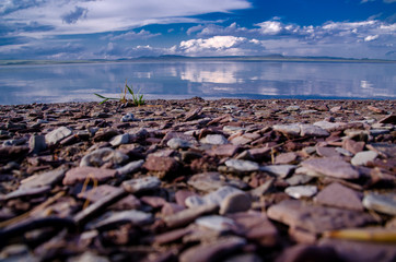 stones on a blue lake