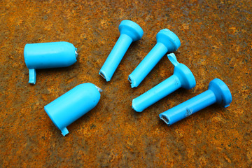 Naklejka premium Blue iron rod on a rusted background for text