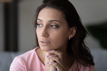 Pensive young beautiful indian Arabic woman look in distance thinking pondering over life problem solution, thoughtful arab mixed race female lost in thoughts imagine or visualize, dilemma concept