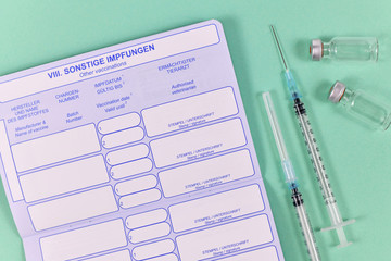 Vaccine concept for pets with empty European vaccination dog passport with syringes and vials