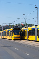 Fototapeta na wymiar Budapest, Hungary: Two yellow modern tramways in the streets of Budapest