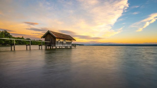 Lake at sunset time lapse. Lake house in Stegen am Ammersee in Bavaria Germany. Nature landscapes 4k.