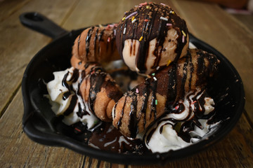 Tequeños with hazelnut cream, cream and vanilla ice cream, served as dessert.