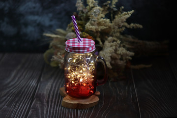 Mug for cocktails and iced tea. Photo with light bokeh from light bulbs.
