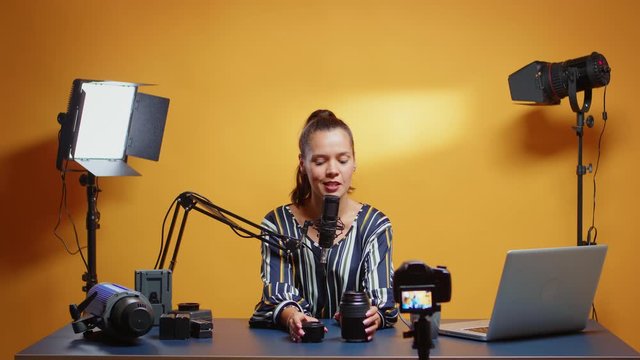 Camera lens comparison from online vlogger in her professional studio. Content creator new media star influencer on social media talking video photo equipment for online internet web show